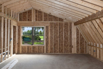 Photo of a wood framed room that has been added on to an existing house structure. 